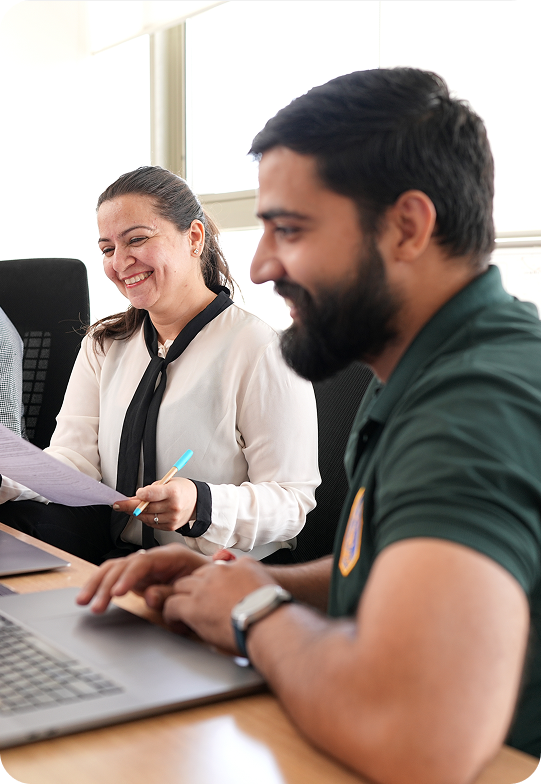 Team reviewing work on a laptop